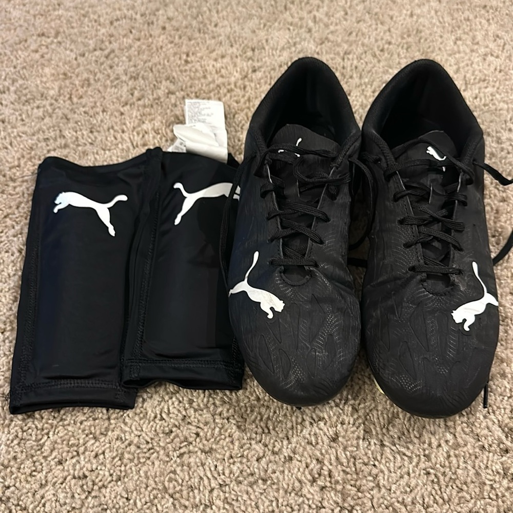 Men’s Puma soccer cleats and matching shin guards